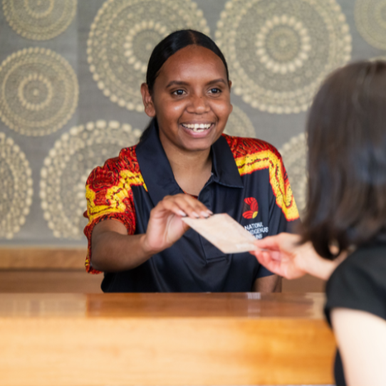NITA trainee checking a guest in at Ayers Rock Resort